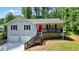 Charming two-story home with a front porch and a bright red front door at 276 Indian Creek Dr, Powder Springs, GA 30127