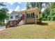 Charming two-story home with a front porch and a bright red front door at 276 Indian Creek Dr, Powder Springs, GA 30127
