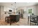 Bright kitchen with white cabinets, stainless steel appliances, and a center island with bar seating at 276 Indian Creek Dr, Powder Springs, GA 30127