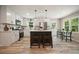 Modern kitchen with an island, stainless steel appliances, white cabinets, and wood flooring at 276 Indian Creek Dr, Powder Springs, GA 30127