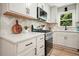 Close up of kitchen featuring updated stainless steel gas range and bright white countertops and backsplash at 276 Indian Creek Dr, Powder Springs, GA 30127