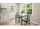 Eat-in kitchen with views of the back yard, modern table and chair set, with white cabinets at 276 Indian Creek Dr, Powder Springs, GA 30127