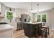 Modern kitchen with stainless steel appliances, white cabinets, an island and views of the backyard at 276 Indian Creek Dr, Powder Springs, GA 30127