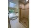 Bright bathroom featuring a walk-in shower, tiled floors, and jetted tub with skylight at 7448 Berea Road, Winston, GA 30187