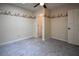 A cozy bedroom featuring gray carpet, an overhead fan and a patterned wallpaper border at 7448 Berea Road, Winston, GA 30187