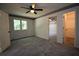 Open bedroom with gray carpet, a ceiling fan, and attached room and closet at 7448 Berea Road, Winston, GA 30187