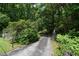 The driveway is long and tree-lined, leading up to the house at 7448 Berea Road, Winston, GA 30187