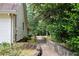 A long, stone-lined walkway alongside a home with white siding at 7448 Berea Road, Winston, GA 30187