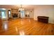 Open-concept living room with hardwood floors, stone fireplace, and piano at 7448 Berea Road, Winston, GA 30187
