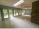 Bright living room with a stone fireplace, tile floor, and multiple windows at 7448 Berea Road, Winston, GA 30187