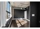 Bedroom with dark walls and hardwood floors with large window and concrete ceiling at 115 W Peachtree Nw Pl # 602, Atlanta, GA 30313