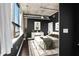 Stylishly decorated bedroom with large windows, exposed pipes and concrete at 115 W Peachtree Nw Pl # 602, Atlanta, GA 30313