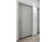 Hallway view of a grey apartment door with a unit number and modern light fixture at 115 W Peachtree Nw Pl # 602, Atlanta, GA 30313
