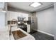 Modern kitchen featuring stainless steel appliances, white cabinets, and stylish backsplash at 115 W Peachtree Nw Pl # 602, Atlanta, GA 30313