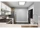 Compact kitchen featuring stainless steel appliances and a stackable washer and dryer at 115 W Peachtree Nw Pl # 602, Atlanta, GA 30313