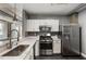 Bright kitchen with stainless steel appliances, white cabinets, and stone countertops at 115 W Peachtree Nw Pl # 602, Atlanta, GA 30313