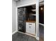 Laundry closet with stacked washer/dryer and modern cabinet at 115 W Peachtree Nw Pl # 602, Atlanta, GA 30313