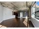 Open-concept living space with hardwood floors, exposed ductwork, and large windows offering abundant natural light at 115 W Peachtree Nw Pl # 602, Atlanta, GA 30313