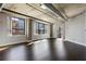 Bright living room with exposed piping and concrete columns surrounding large city view windows at 115 W Peachtree Nw Pl # 602, Atlanta, GA 30313