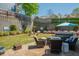 Inviting backyard oasis with a patio, hot tub, manicured lawn, retaining wall, and colorful flowerbeds at 2075 Old Georgian Nw Ter, Atlanta, GA 30318