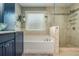 Bathroom featuring a bathtub with tile backsplash and glass enclosed shower at 2075 Old Georgian Nw Ter, Atlanta, GA 30318