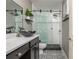 Modern bathroom with glass shower enclosure, decorative tile flooring, and black vanity with vessel sink at 2075 Old Georgian Nw Ter, Atlanta, GA 30318