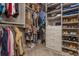 Organized walk-in closet with custom shelving, hanging racks, drawers, and ample space for storage of personal items at 2075 Old Georgian Nw Ter, Atlanta, GA 30318