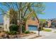 Charming two-story home features a well-manicured front yard and blue garage doors at 2075 Old Georgian Nw Ter, Atlanta, GA 30318