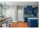 Open-concept kitchen with blue cabinets, a dining area, and stainless steel appliances at 2075 Old Georgian Nw Ter, Atlanta, GA 30318
