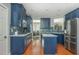 Bright kitchen showcasing blue cabinets, stainless steel appliances, and a functional layout at 2075 Old Georgian Nw Ter, Atlanta, GA 30318