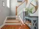 Stairway with hardwood and carpeted steps, complemented by a stylish table and decor at 2075 Old Georgian Nw Ter, Atlanta, GA 30318