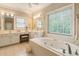 Bathroom showcasing white tiled floors, double vanity, and soaking tub with jets at 2584 Oglethorpe Ne Cir, Brookhaven, GA 30319