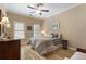 Bedroom showcasing hardwood floors, ceiling fan, windows, and lamps at 2584 Oglethorpe Ne Cir, Brookhaven, GA 30319