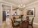 Inviting dining room featuring hardwood floors, a chandelier, and a glimpse into the kitchen at 2584 Oglethorpe Ne Cir, Brookhaven, GA 30319