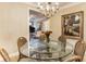 Charming dining room with a glass-top table, wicker chairs, and view into the living room at 2584 Oglethorpe Ne Cir, Brookhaven, GA 30319
