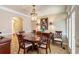 Elegant dining room featuring a chandelier, wood table, and access to outdoor area at 2584 Oglethorpe Ne Cir, Brookhaven, GA 30319