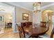 Dining room with hardwood floors, elegant lighting, and views into adjacent living spaces at 2584 Oglethorpe Ne Cir, Brookhaven, GA 30319