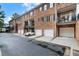 Charming brick townhouses with individual garages and balconies create a welcoming community atmosphere at 2584 Oglethorpe Ne Cir, Brookhaven, GA 30319