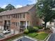 Brick townhouses with well-maintained landscaping offering a glimpse into community living with garages and balconies at 2584 Oglethorpe Ne Cir, Brookhaven, GA 30319
