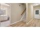 Inviting hallway that leads to a bathroom on the left, a staircase, and a front door with paneled glass at 2584 Oglethorpe Ne Cir, Brookhaven, GA 30319