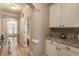 Inviting hallway with hardwood floors, leading to arched doorway and french doors at 2584 Oglethorpe Ne Cir, Brookhaven, GA 30319