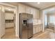 Stainless steel refrigerator complements the kitchen's granite countertops and custom cabinets at 2584 Oglethorpe Ne Cir, Brookhaven, GA 30319