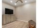 Minimalist living room with hardwood floors, a large TV console, and unique decor pieces adding character at 2584 Oglethorpe Ne Cir, Brookhaven, GA 30319