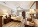 Bedroom featuring wood floors, tray ceiling, ceiling fan, and large mirror at 2584 Oglethorpe Ne Cir, Brookhaven, GA 30319