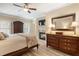 Bedroom featuring wood floors, tray ceiling, ceiling fan, and fireplace at 2584 Oglethorpe Ne Cir, Brookhaven, GA 30319