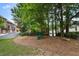 Community playground with slide and swing set, surrounded by mulch and mature trees for shade at 2584 Oglethorpe Ne Cir, Brookhaven, GA 30319