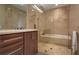 Elegant bathroom featuring a glass-enclosed shower and tub combination with marble tile surround at 3325 Piedmont Ne Rd # 2501, Atlanta, GA 30305