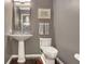 Chic powder room with pedestal sink and modern fixtures, featuring hardwood flooring at 3325 Piedmont Ne Rd # 2501, Atlanta, GA 30305