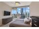Modern bedroom with cityscape view, offering lots of natural light from the large picture window at 3325 Piedmont Ne Rd # 2501, Atlanta, GA 30305
