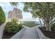 Dog run area with artificial grass, plants, and trees on a sunny rooftop in a city setting at 3325 Piedmont Ne Rd # 2501, Atlanta, GA 30305